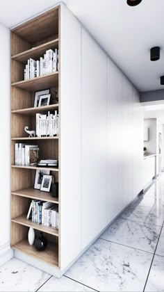 a book shelf in the corner of a room with white walls and marble flooring