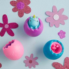 an assortment of play doughnuts and toys on a blue background with pink flowers