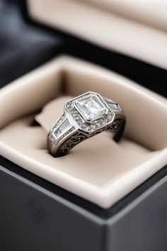 an engagement ring with two baguets in a box