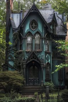 an old victorian house with ivy growing on the windows and door, surrounded by greenery