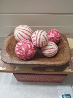 some red and white balls in a wooden bowl