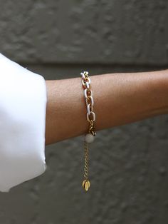 The white enamel on the gold chain bracelet adds a sleek and elegant touch, while the stainless steel base provides durability. Chain is made of stainless steel, gold ION plated with 18k gold. This bracelet effortlessly elevates any ensemble, making a bold yet refined statement. Elegant and stylish, it's a versatile accessory that complements both formal and trendy attire, adding a touch of luxury to any look. Length of the chain is 16 inches including the clasp. There is 2'' extender chain for Modern White Chain Jewelry, White Chain Bracelet Jewelry, Modern White Jewelry With Delicate Chain, White Metal Chain Bracelet, White Chain Bracelet, White Minimalist Metal Jewelry, Dainty White Jewelry With Gold Chain, Minimalist White Metal Jewelry, Elegant White Chain Bracelet With Extender