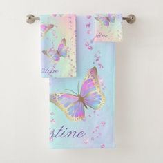 two towels with butterflies on them and the words shine written in purple, blue, and pink