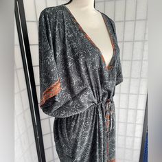 It Doesn’t Get Any Easier Than This One-And-Done Dress Caftan From Karma Highway. One Size Means It Fits Almost Everyone, Just Cinch The Waist Or Leave It Loose And Easy. With A Bandeau Or Tank Underneath, Or As A Classy Swimsuit Coverup, You Can Wear This Just About Anywhere. This Is A Beautiful Floral Pattern In Different Shades Of Gray With Orange Ands Cream Accents. Picture With Model Is Of Another Color Dress, Wearing A Bandeau Bra Underneath. Bra Top Available In Another Listing. Bohemian Kaftan With Tie Waist And Kimono Sleeves, Bohemian V-neck Kaftan With Tie Waist, Bohemian Orange Dresses With Kimono Sleeves, Orange Long Sleeve Bohemian Kaftan, Orange V-neck Kimono For The Beach, Bohemian Orange Wrap Kimono, Orange Tunic Kaftan For Beach Cover-up, Orange Long Bohemian Cover-up, Long Orange Bohemian Cover-up