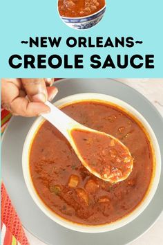 a bowl of soup with a spoon in it and the words new orleans criole sauce