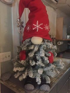 a christmas tree with a gnome hat on top