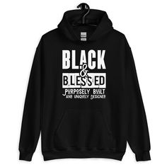 Black & Blessed: Purposely Built And Uniquely Designed Black Pride Gift Unisex Hoodie Everyone needs a cozy go-to hoodie to curl up in, so go for one that's soft, smooth, and stylish. It's the perfect choice for cooler evenings! * 50% cotton, 50% polyester  * Double-lined hood * Double-needle stitching throughout  * Air-jet spun yarn with a soft feel and reduced pilling * 1x1 athletic rib knit cuffs and waistband with spandex * Front pouch pocket Queen Black, Pride Gifts, Black Pride, Knit Cuff, Lives Matter, Black Lives, Black Lives Matter, Pocket Pouch, Unisex Hoodies