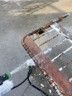 an old wooden chair sitting on the sidewalk