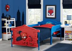 a child's bedroom with blue walls and spiderman bedding