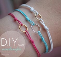 three different bracelets with gold rings on each one and pink, blue, and white cords