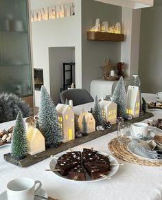 a table topped with plates and cups filled with desserts