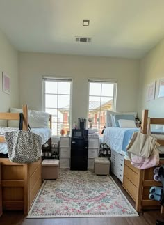 a room filled with lots of wooden furniture and windows next to a rug on top of a hard wood floor