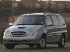 a silver van is parked in front of some houses