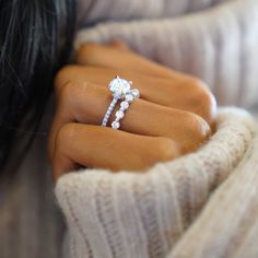 a woman's hand holding a diamond ring with the words brilliant earth above it