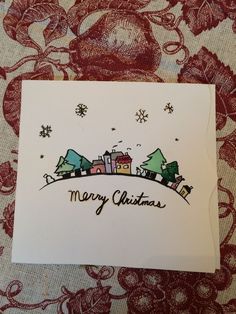 a christmas card with houses and snowflakes on the top that says merry christmas