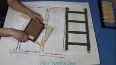 a person is working on an unfinished piece of paper that has been cut out to look like a ladder