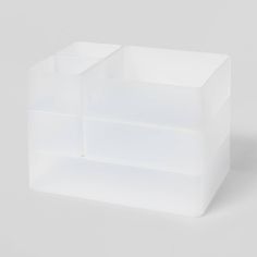 an empty white plastic container on a gray background