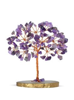 a small tree with purple stones on it