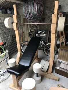 a bench and some stools in a room with many items on the floor,