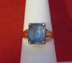 An Original 1960's Swedish 18 Kt Yellow Gold Blue Topaz Ladies Ring - Blue Beauty (Size 6). Visit this shop for a wide variety of Vintage Quality Jewelry, Art, and Collectibles. ~Age (approximate): 1960's ~Material(s): 18 Karat Yellow Gold ~Approx. Size: 6 ~Approx. Weight: 1.4 dwt ~Signature / Brand: Unsigned. ~Condition: Very Good. ~International Shipping: Is Available, please contact us for a quote. ~Inventory #: 6129 Vintage Blue Topaz Ring With Prong Setting, Vintage Blue Topaz Ring For Formal Occasions, Blue Solitaire Rectangular Jewelry, Blue Rectangular Solitaire Jewelry, Blue Solitaire Emerald Ring In Classic Style, Blue Solitaire Emerald Ring Classic Style, Rectangular Blue Topaz Ring With Prong Setting, Classic Blue Emerald Ring With Prong Setting, Blue Topaz Solitaire Ring For Formal Occasions