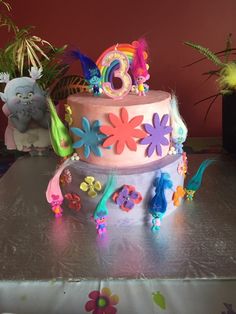 a birthday cake decorated with flowers and decorations