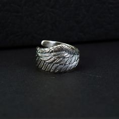 ----♛Handcrafted Feather Sterling Silver Ring♛ --- Featuring a majestic eagle wing design meticulously handcrafted by skilled artisans. Each detail is intricately carved and polished to perfection, resulting in a lifelike feather texture that is truly mesmerizing. This stunning piece embodies the grace and strength of the eagle, making it a symbol of freedom and power. Elevate your style with this unique and intricately crafted ring, sure to captivate attention wherever you go. Materials: 925 Sterling Silver Ring Width: 0.45" Ring Weight: 6.7g Ring Size: Adjustable 9-12 US ☛ This silver men necklace suitable for any occasion and everyday wear ☛ This men jewelry is a very special gift for valentine's day gifts, birthday gifts, wedding gifts, Christmas gifts, party, anniversary gifts and mor Unique Sterling Silver Jewelry, Feather Texture, Wing Design, Eagle Ring, Eagle Wings, Silver Bird, Feather Ring, Feather Design, Men Jewelry