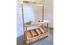 a wooden table with drawers on it and a sign that says farmers market