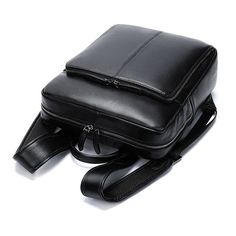 a black leather bag sitting on top of a white floor