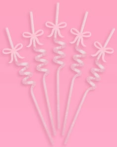 six white bows and ribbons on pink background