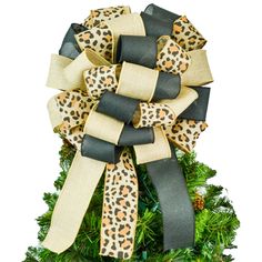 a leopard print bow on top of a christmas tree