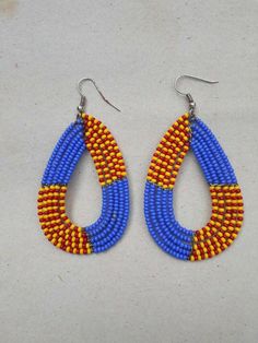 Traditional Beaded Dangle Hoop Earrings, Unique Beaded Dangle Hoop Earrings, Yellow Beaded Teardrop Earrings, Handmade Teardrop Beads For Jewelry Making, Round Chandelier Earrings With Dangling Beads, Colorful Beaded Dangle Teardrop Earrings, Beaded Teardrop Dangle Earrings, Traditional Long Drop Beaded Earrings With Dangling Beads, Blue Beaded Drop Earrings