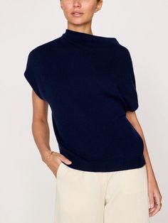 In a luxe 100% cashmere, this modern vest/top is designed to be worn on its own or layered as a vest. Featuring a draped funnel neck, rounded dropped shoulders and a relaxed shape, this sleeveless sweater is the epitome of effortlessness and versatility. Part of our ‘Kinder To The Environment’ collection, it is made RWS-certified, traceable yarn which means it adheres to stringent animal welfare standards. Relaxed fit Draped funnel neckline Sleeveless Rounded dropped shoulders Ribbed back neck, Vince Funnel Neck Sweater Coastal, Luxury Funnel Neck Top With Ribbed Cuffs, Luxury Funnel Neck Top For Workwear, Luxury Classic Funnel Neck Outerwear, Luxury Oversized Tops With Funnel Neck, Luxury Black Funnel Neck Top, Luxury Funnel Neck Sweater, Luxury Chic Merino Wool Knit Top, Modern Luxury Funnel Neck Sweater