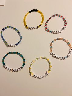 six bracelets with words written on them arranged in the shape of a circle together