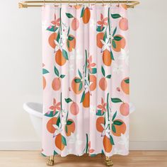 an orange shower curtain with white flowers and leaves on it, in front of a bathtub