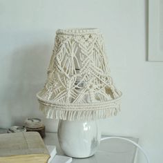 a white table lamp sitting on top of a glass table