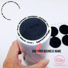 a hand holding a white cup with black writing on it and the words add your business name