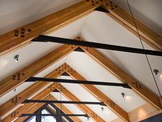 the inside of a building with wooden beams