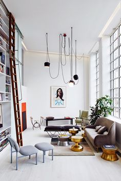 a living room filled with furniture and lots of windows