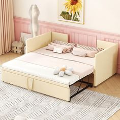 a bed with a pull out trundle on top of it in a room