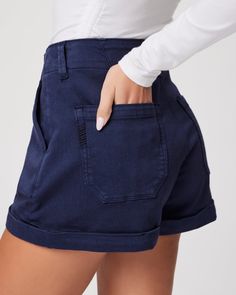 The Brooklyn Short is designed with vintage-inspired trouser pockets with stitching details, criss cross back belt loops, a wide waistband, double button closure, front pleats and a cuffed hem. This effortlessly chic short comes in a vintage navy blue hue in a super soft fabric with the perfect amount of stretch. Rolled Hem Bottoms For Workwear, Mid-rise Workwear Shorts With Pockets, Short Workwear Bottoms With Patch Pockets, Cotton Workwear Shorts With Paperbag Waist, Chic Cotton Shorts With Welt Pockets, High Waist Cotton Bottoms With Rolled Hem, Utility Style Bottoms For Workwear In Short Length, High-rise Relaxed Fit Shorts For Workwear, High Rise Relaxed Fit Shorts For Workwear