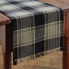 a black and white plaid table runner on a wooden table