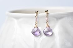 An elegant drop earring, featuring a 14k gold-filled ball stud, pink tourmaline and a gorgeous pink amethyst faceted briolette drop. These gorgeous drop earrings are carefully crafted from 14k gold-filled wire. The stud earring is adorned with a 14 gold-filled ball. From it, dangles a pink tourmaline and then ends in a beautiful faceted pink amethyst briolette. They are incredibly feminine and elegant. Ideal for brides seeking elegance or bridesmaids aiming for a coordinated look, these earrings are also a thoughtful present for yourself, a cherished mother on Mother's Day, a romantic partner on Valentine's Day, or to celebrate a meaningful anniversary. Fastening is made with a gold-filled butterfly clasp. - Dimensions - Approximate length of earring from top to bottom: 2.4 cm - Made from Delicate Bridal Earrings, Romantic Partner, Drop Earrings Gold, Light Earrings, Amethyst Jewelry, Earrings Pink, Pink Amethyst, Amethyst Earrings, Drop Earring