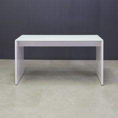 a white table sitting on top of a tiled floor