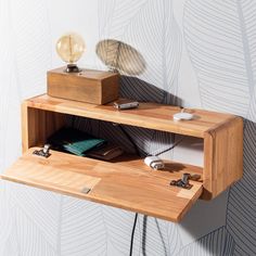 a wooden shelf with some books on it and a light bulb sitting on top of it