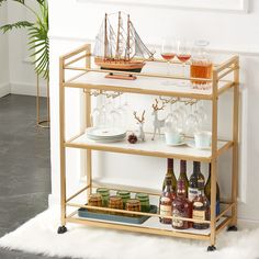 a bar cart filled with wine glasses and bottles