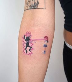 a person with a tattoo on their arm has a drawing of a man hitting a woman