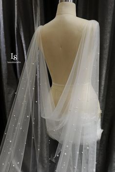 the back of a mannequin wearing a white veil