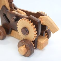 a wooden toy truck with gears attached to it