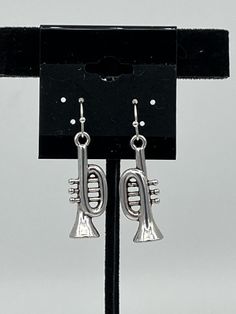 These lovely earrings would be great for any music lover. They consist of 3d silvertone trumpet charms. The earrings measure about 1-1/2 inch long in total including the sterling silver hooks. Be Great, Lovely Earrings, Music Lover, Silver Tone, Dangle Earrings, Charms, Sterling Silver, Music, Silver