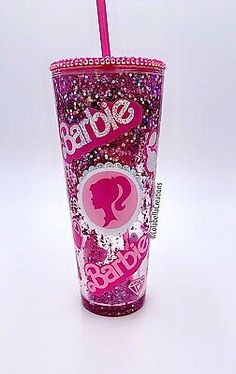 a pink and purple cup with the word barbie on it's side, in front of a white background